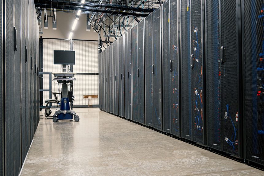 Racks metálicos com servidores, equipamentos de rede e cabos em um data center moderno